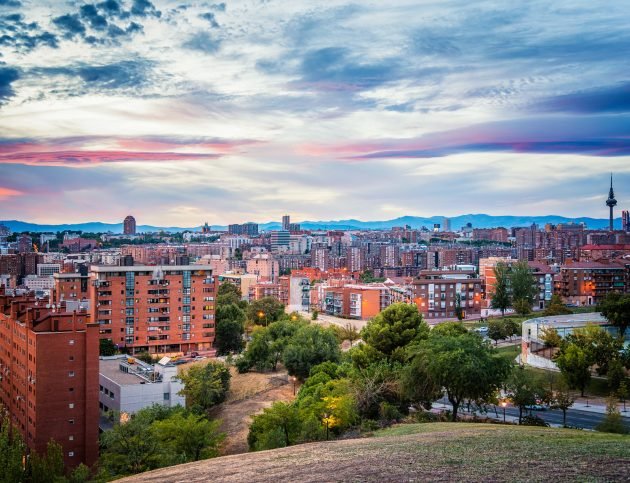 Madrid cityscape at dusk from a residential district and mountain range at background